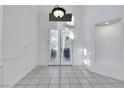 Bright foyer featuring tiled floors, high ceilings, and an ornate glass double-door entrance at 249 Gentle Springs Dr, Henderson, NV 89012