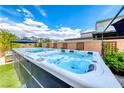 Backyard hot tub and artificial grass create a relaxing outdoor space at 2637 Via Monet, Henderson, NV 89044