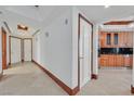 Bright hallway with travertine flooring, wood trim, and access to the kitchen at 2877 Paradise Rd # 1804, Las Vegas, NV 89109