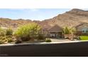 Charming home featuring a three-car garage and desert landscaping at 2927 The Peaks Ln, Las Vegas, NV 89138