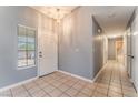 Inviting foyer with tile flooring, light gray walls and a view into the house beyond at 3108 Leafwood St, Las Vegas, NV 89108
