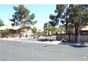 A gated community entrance featuring dual gates, mature landscaping, and well-maintained street at 3954 Saddlewood Ct, Las Vegas, NV 89121
