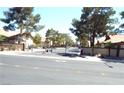 View of the gated community entrance with dual gates and mature landscaping at 3954 Saddlewood Ct, Las Vegas, NV 89121