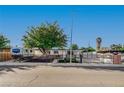 Charming single story home with secure metal fencing, large tree, and RV parking at 4284 Parkdale Ave, Las Vegas, NV 89121