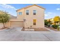 Two-story home showcasing a neutral stucco exterior, two-car garage, well-kept landscaping, and inviting curb appeal at 4533 Lime Straight Dr, Las Vegas, NV 89115