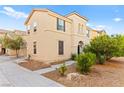 Charming two-story home with desert landscaping, neutral stucco exterior, arched entry and accent shutters at 4533 Lime Straight Dr, Las Vegas, NV 89115