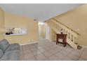 Inviting living room with tile flooring, stairs, and a charming electric fireplace at 4770 Topaz St # 108, Las Vegas, NV 89121
