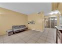 Cozy living room featuring tile flooring and a sliding glass door at 4770 Topaz St # 108, Las Vegas, NV 89121