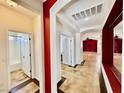 Inviting hallway with decorative red beams, showcasing the open floor plan and leading to the bathroom and bedrooms at 5019 Quiet Falls Ct, Las Vegas, NV 89141