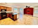 Well-equipped kitchen boasts a central island, stainless steel appliances, and an open layout to the dining area at 5019 Quiet Falls Ct, Las Vegas, NV 89141