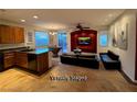 Open-concept living space with a granite kitchen island and designated living room at 5019 Quiet Falls Ct, Las Vegas, NV 89141