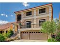 Two-story home featuring a spacious two car garage and a small balcony at 5448 Tulip Hill Ave, Las Vegas, NV 89141