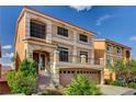 Two-story home featuring a spacious two car garage, entryway steps, and a small balcony at 5448 Tulip Hill Ave, Las Vegas, NV 89141