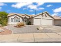 Charming home showcasing a well-maintained front yard with desert landscaping and a two-car garage at 556 Decidedly St, Henderson, NV 89015