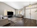 Bright living room featuring wood flooring and neutral-toned furniture at 5912 Hollowridge Rd, North Las Vegas, NV 89031