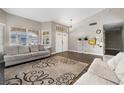 Spacious living room with wood floors, modern decor, and abundant natural light at 5912 Hollowridge Rd, North Las Vegas, NV 89031