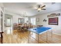 Open-concept dining room featuring a chandelier, a dining table for eight, and hardwood floors at 6021 Winter Meadow St, Las Vegas, NV 89130