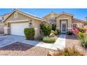 Well-kept single-story home featuring desert landscaping, a two-car garage, and a welcoming front entrance at 6021 Winter Meadow St, Las Vegas, NV 89130