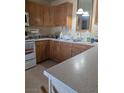 Kitchen view with wood cabinets, laminate countertops, and white appliances at 626 Kimberly Ave, Pahrump, NV 89060