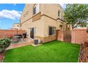 Private backyard with artificial grass, a brick patio, and space for outdoor dining at 6312 Snap Ridge St # 101, North Las Vegas, NV 89081