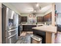 Modern kitchen features stainless steel appliances, ample counter space, and dark wood cabinetry at 6312 Snap Ridge St # 101, North Las Vegas, NV 89081