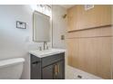 Bathroom featuring modern sink, stylish vanity, a sleek mirror and a beautifully tiled walk-in shower at 6320 Dayton Ave, Las Vegas, NV 89107