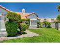 Charming single-story home with lush lawn and unique landscaping at 6432 Jean Lee Dr, Las Vegas, NV 89108