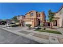 Charming two-story home with a tile roof, complemented by a well-manicured front yard and an attached two-car garage at 644 Mauna Kea Pl, Henderson, NV 89011