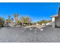 A large paved driveway provides ample parking, complemented by lush landscaping and privacy gates at 6965 Tara Ave, Las Vegas, NV 89117