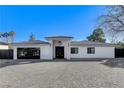 Sophisticated home boasting a decorative tile roof, modern design, and a spacious paved driveway at 6965 Tara Ave, Las Vegas, NV 89117