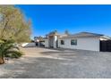 Expansive one-story home offering a generous driveway, stylish design, and a secure gated entrance at 6965 Tara Ave, Las Vegas, NV 89117