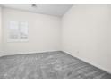 Bright bedroom features soft carpet, window with plantation shutters, and neutral paint at 717 Monroe Hill Pl, Henderson, NV 89011