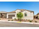 Stylish single-story home with a tile roof, spacious two-car garage, and attractive desert landscaping at 717 Monroe Hill Pl, Henderson, NV 89011
