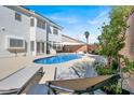 Private backyard oasis featuring a pool, lounge chairs, and a well-manicured landscape at 7492 Midfield Ct, Las Vegas, NV 89120