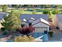 Charming single-story home featuring a two-car garage and picturesque landscaping near the golf course at 7509 Chaffinch St, North Las Vegas, NV 89084
