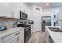 Modern kitchen with marble countertops, stainless steel appliances, and ample cabinet space at 778 Dainty Daffodil St, Henderson, NV 89011