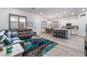 Open-concept living space featuring a comfortable couch and seamless flow to the kitchen at 778 Dainty Daffodil St, Henderson, NV 89011