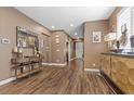 Bright hallway with hardwood floors and art display at 8013 Green River Knob St, Las Vegas, NV 89113