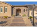 Inviting front entrance with stone accents, a decorative light post, and desert landscaping at 8228 Fulton Ranch St, Las Vegas, NV 89131