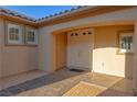 Covered front porch featuring a double-door entry and decorative tile flooring at 8228 Fulton Ranch St, Las Vegas, NV 89131