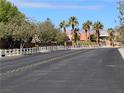 A peaceful street view with palm trees and well-maintained landscaping at 8688 Tomnitz Ave # 101, Las Vegas, NV 89178