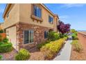 Well-maintained home exterior with stone accents and verdant landscaping at 9457 Alma Ridge Ave, Las Vegas, NV 89178