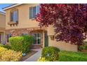 Charming home entrance with a stone accent wall and mature landscaping at 9457 Alma Ridge Ave, Las Vegas, NV 89178