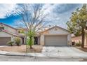 Inviting single-story home with a two-car garage and desert landscaping at 9535 Golden Scots Ct, Las Vegas, NV 89123