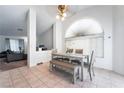 Bright dining room area featuring tile floors and a table with seating for six at 988 Flapjack Dr, Henderson, NV 89014