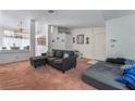Open living room has carpeted floors with a gray sofa and plenty of natural light at 988 Flapjack Dr, Henderson, NV 89014