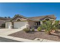 Attractive single-story home with a three-car garage, desert landscaping, and a well-kept exterior at 10212 Donald Weese Ct, Las Vegas, NV 89129