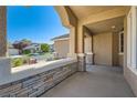 Covered front porch with stone columns offering a relaxing outdoor space at 10212 Donald Weese Ct, Las Vegas, NV 89129