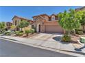 Inviting two-story home with a stone accent and two-car garage surrounded by mature trees in a friendly neighborhood at 10353 Settlers Run Ave, Las Vegas, NV 89166