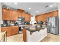 Well-lit kitchen with stainless steel appliances, granite countertops, and ample cabinet space at 10353 Settlers Run Ave, Las Vegas, NV 89166
